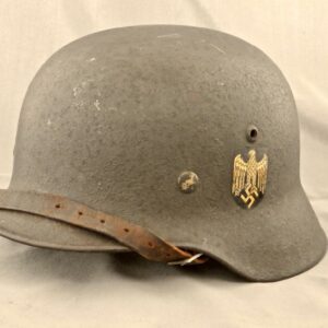 German M35 combat helmet with textured overpaint.